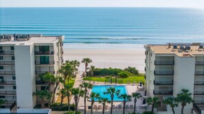 A resort with a pool, beach view, and multiple balconies. - Oceanfront Crescent Beach • 3 King Beds • Private Terrace • Pool (Saint Augustine)