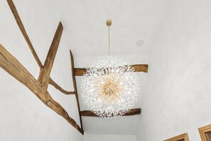 A room with exposed wooden beams and a central chandelier. - Spacious Luxury Barn| Countryside Stay in Newburgh (Wigan)