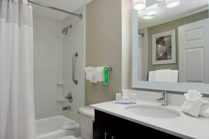 A modern bathroom with a shower, toilet, and sink. - TownePlace Suites Fort Worth SW/TCU 1BR Suite (Fort Worth)