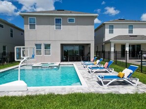 A residential building with a swimming pool, outdoor seating, and a basketball hoop. - 6 BD/ 6.5 BA/ Encore Resort at Reunion (404 SS) (Kissimmee)