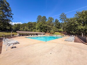 A swimming pool with lounge chairs and a covered area, surrounded by trees. - Near Helen | Dog-Friendly Mountain Retreat + Pool (Sautee Nacoochee)