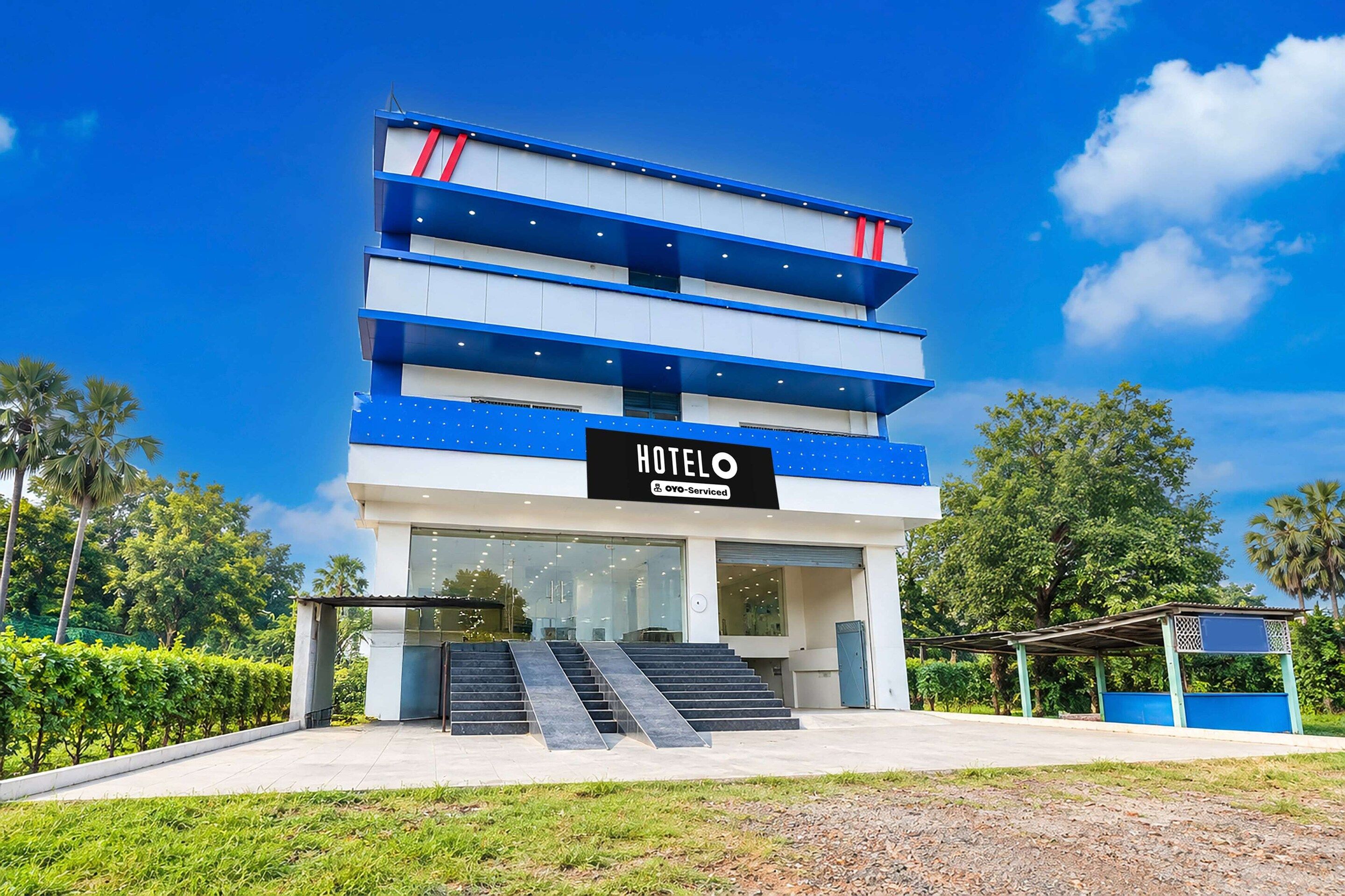 A multi-story hotel with a sign reading 'HOTEL' and 'YO-Serviced'.