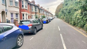 A street lined with terraced houses, parked cars, and a hedge on one side. - Temporary Medway Kent Homel Families & Relocation (Chatham)