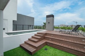 A rooftop deck with a pool, outdoor seating, and a staircase. - Asunción 2BR | Pool, Gym, Balcony & Parking (Asunción)