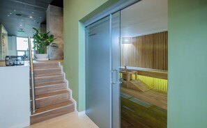 A modern interior with a staircase leading to a wooden deck area. - Modern Studio with Pool&Gym near Paseo La Galeria (Asunción)