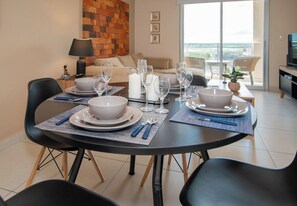 A dining area with a round table set for four, surrounded by black chairs. - Quiet Retreat, Full Kitchen & Desk, City Views (Asunción)