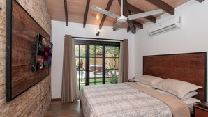 A bedroom with a bed, a ceiling fan, an air conditioning unit, and a view through a glass door. - 4BR Home | Private Pool, Jacuzzi & BBQ (San Bernardino)