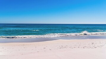 A beach with a clear sky and calm sea.