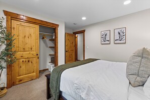 A bedroom with a bed, a closet, and a hallway. - Cabin Near Brundage | Hot Tub · Outdoor Movies (McCall)