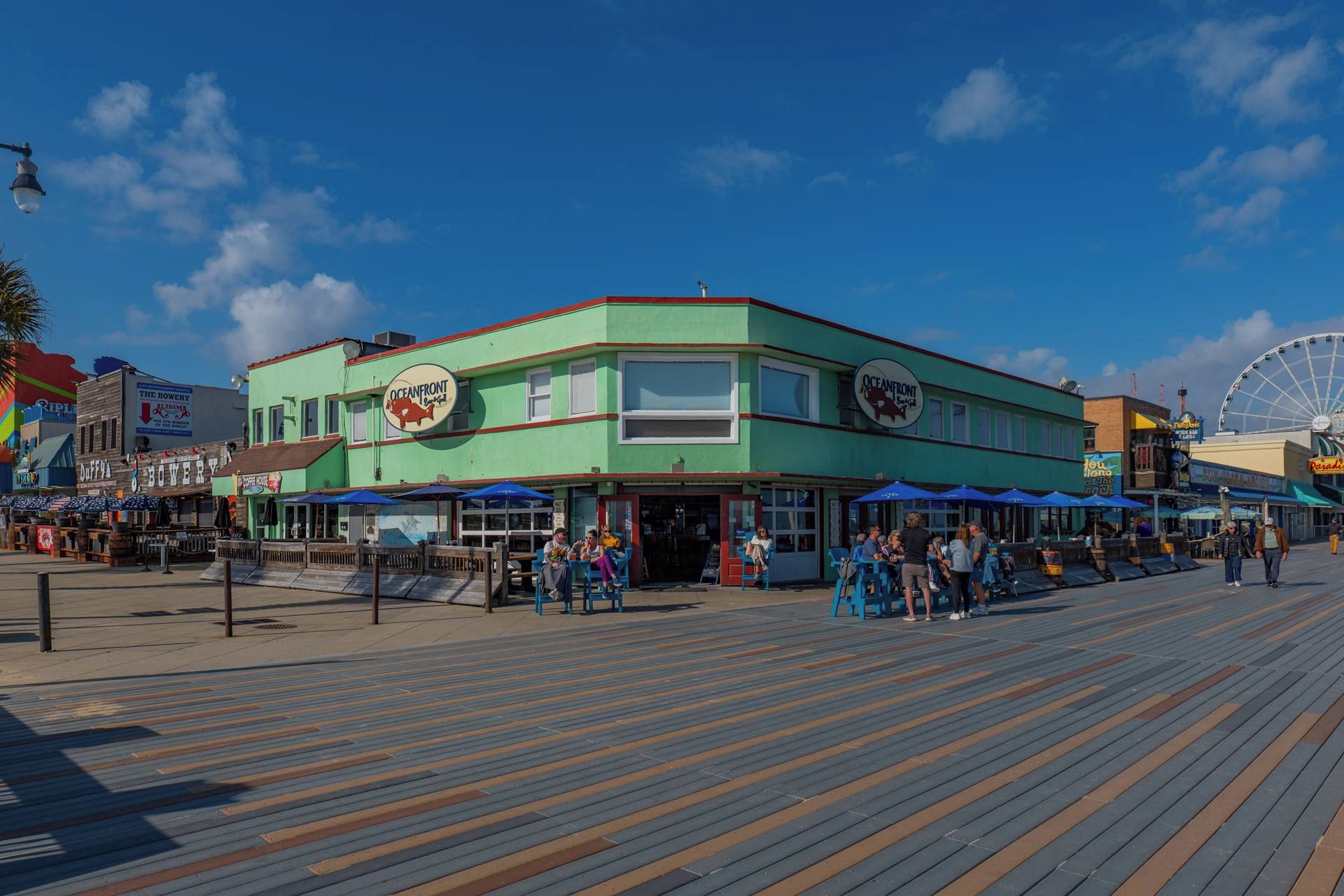A waterfront boardwalk with restaurants and shops.