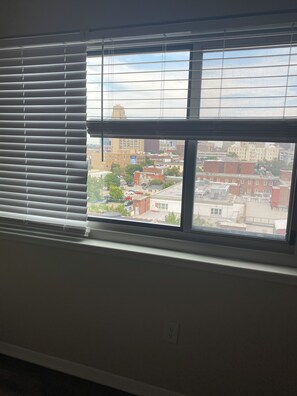 Una habitación con un ventanal grande con vistas a un paisaje urbano.