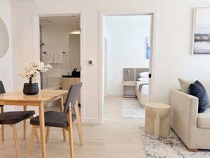 A modern living room with a dining area, a sofa, and a coffee table. - Downtown Miami Oasis Pool, Gym & City Views (Miami)