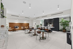A modern interior with a dining area, kitchen, and seating space. - Downtown Miami Oasis Pool, Gym & City Views (Miami)