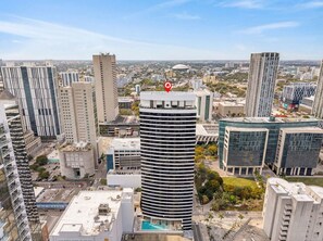 A high-rise building with a rooftop pool, surrounded by other tall buildings in an urban setting. - Urban Luxury Studio Miami (Miami)
