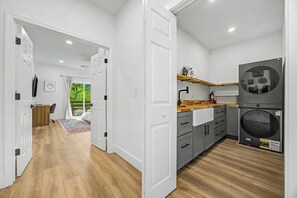 A modern kitchen with grey cabinets, a double oven, and a wooden countertop. - Lockwood Luxe - Arcade, Axe Throwing, Firepit, Two Kings (Atlanta)