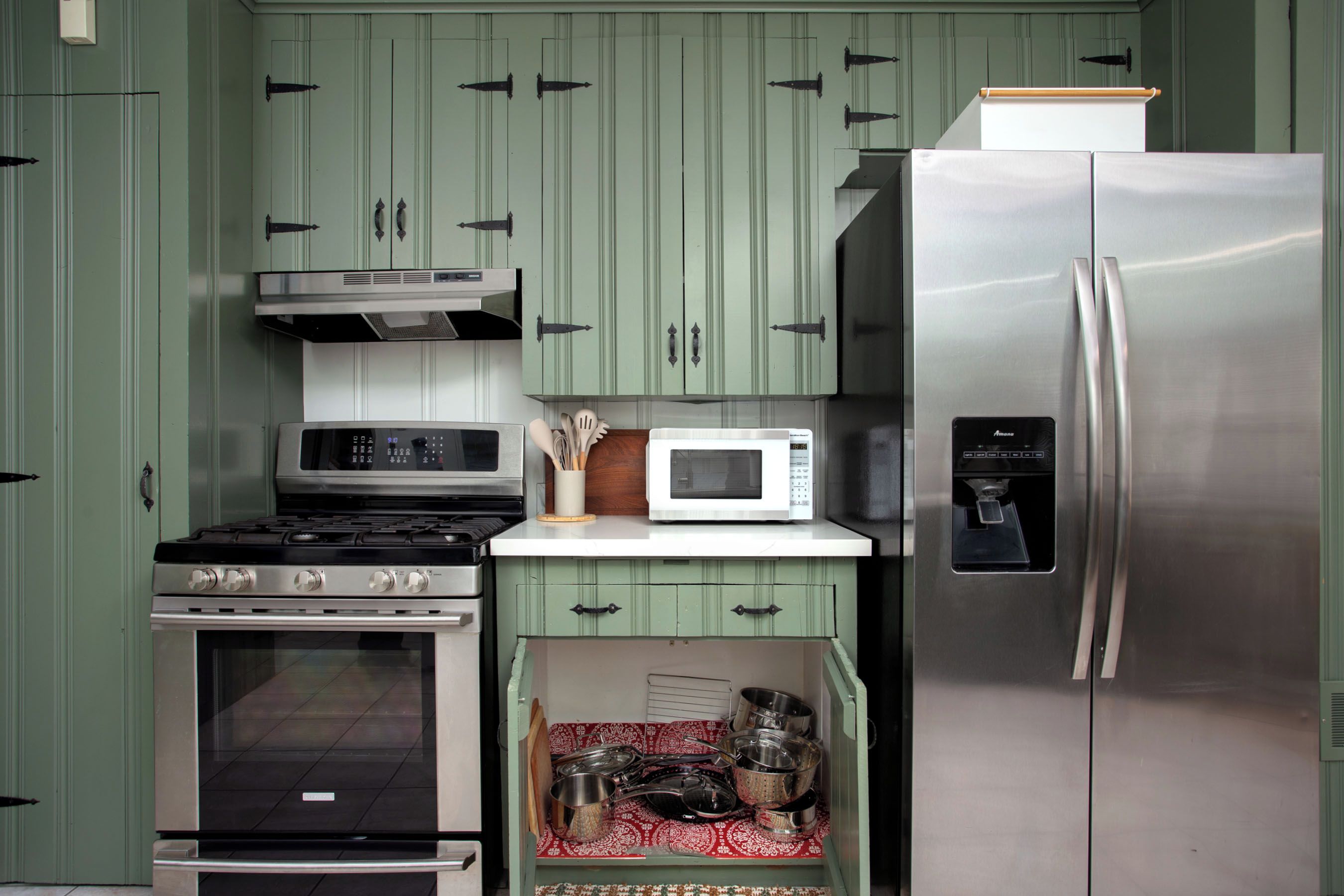 A kitchen with a stainless steel refrigerator, a microwave, a stove, and a built-in oven.