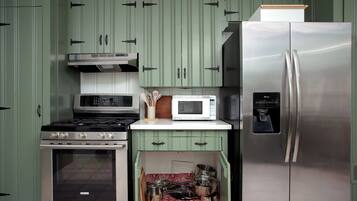 A kitchen with a stainless steel refrigerator, a microwave, a stove, and a built-in oven.
