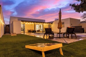 A residential backyard with a patio, outdoor furniture, and a pool. - HEATED POOL - Minutes to Westgate District & Stadiums (Phoenix)