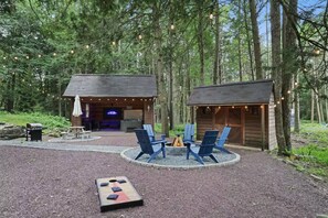 A rustic cabin with a fire pit and outdoor seating. - Pine & Peace Retreat | Hot Tub | Fire Pit (Blakeslee)