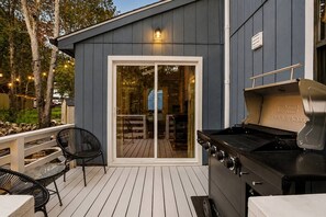A deck with a barbecue grill and outdoor seating. - Putting Green | Hot Tub | Sauna | Theater | Arcade (Coolbaugh Township)