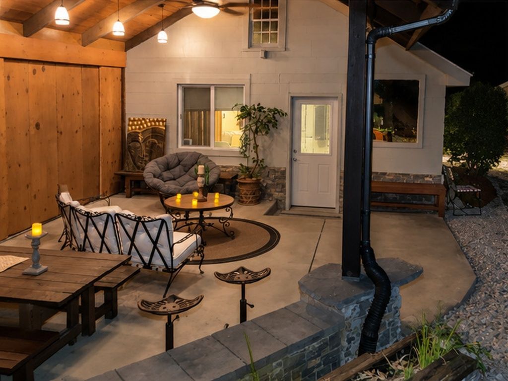 An outdoor patio area with seating, a door, and a window.