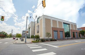 A modern building with a large glass facade, a crosswalk, and traffic lights at an intersection. - Downtown Florence Getaway - Shops, Cafés & Museums (Florence)