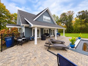 A house with a covered patio, outdoor seating, and a swimming pool. - Relaxing 2-bedroom pool house - Bedford, IN. Easy drive for IU Football (Bedford)