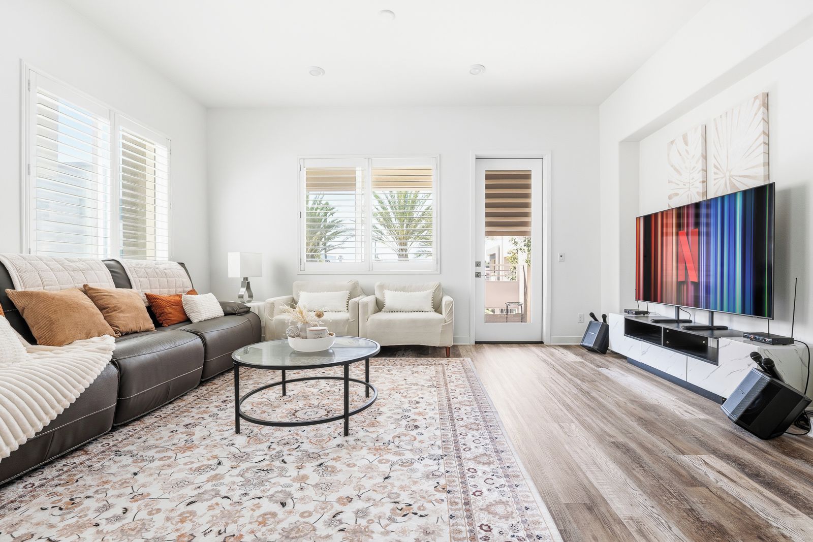 A modern living room with a sofa, coffee table, and TV.