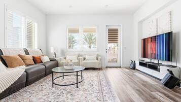 A modern living room with a sofa, coffee table, and TV.