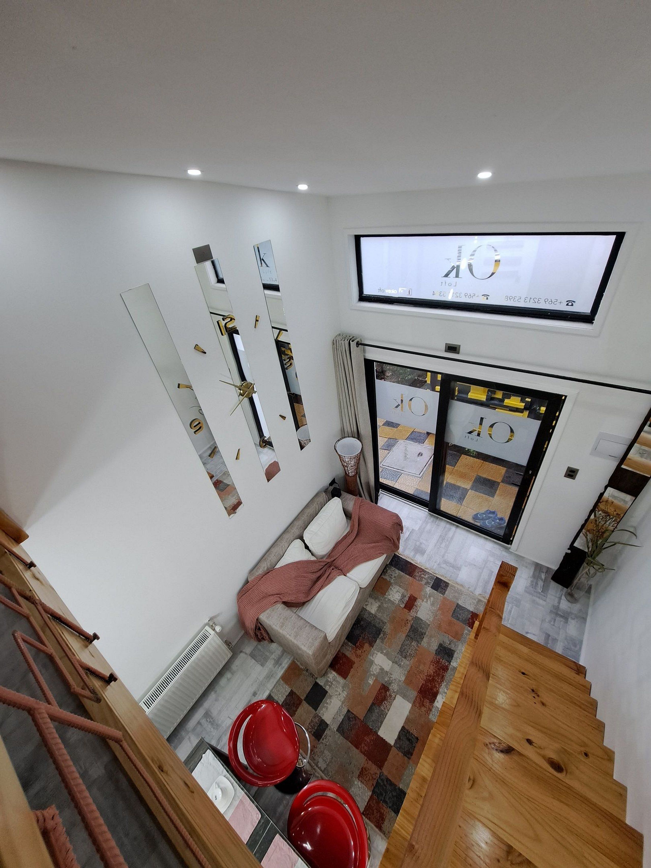 A modern interior with a sofa, a television, and a patterned floor.