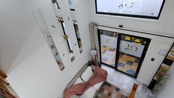 A modern interior with a sofa, a television, and a patterned floor.