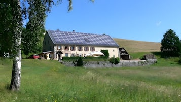 Una casa con tetto spiovente e pannelli solari.
