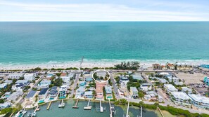 A coastal town with a marina, beachfront, and residential buildings. - 3rd Floor OceanView Condo Steps to Beach - Shared Pool & Putting Green - On-Site Parking (Bradenton Beach)
