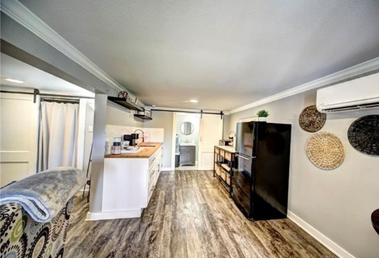 A compact kitchen with a central island, a refrigerator, and a dining area with a table and chairs.