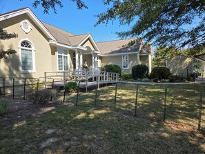 A residential house with a covered porch, a front yard with a fence, and a small shed. - Beautiful Waterfront Property, Dock, Handicap Facilities and Wonderful Sunsets (Lancaster)