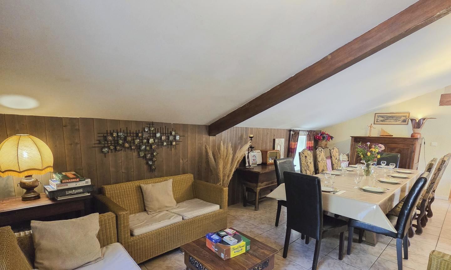 A cozy living room with a sofa, a coffee table, and a dining area with a table set for four.