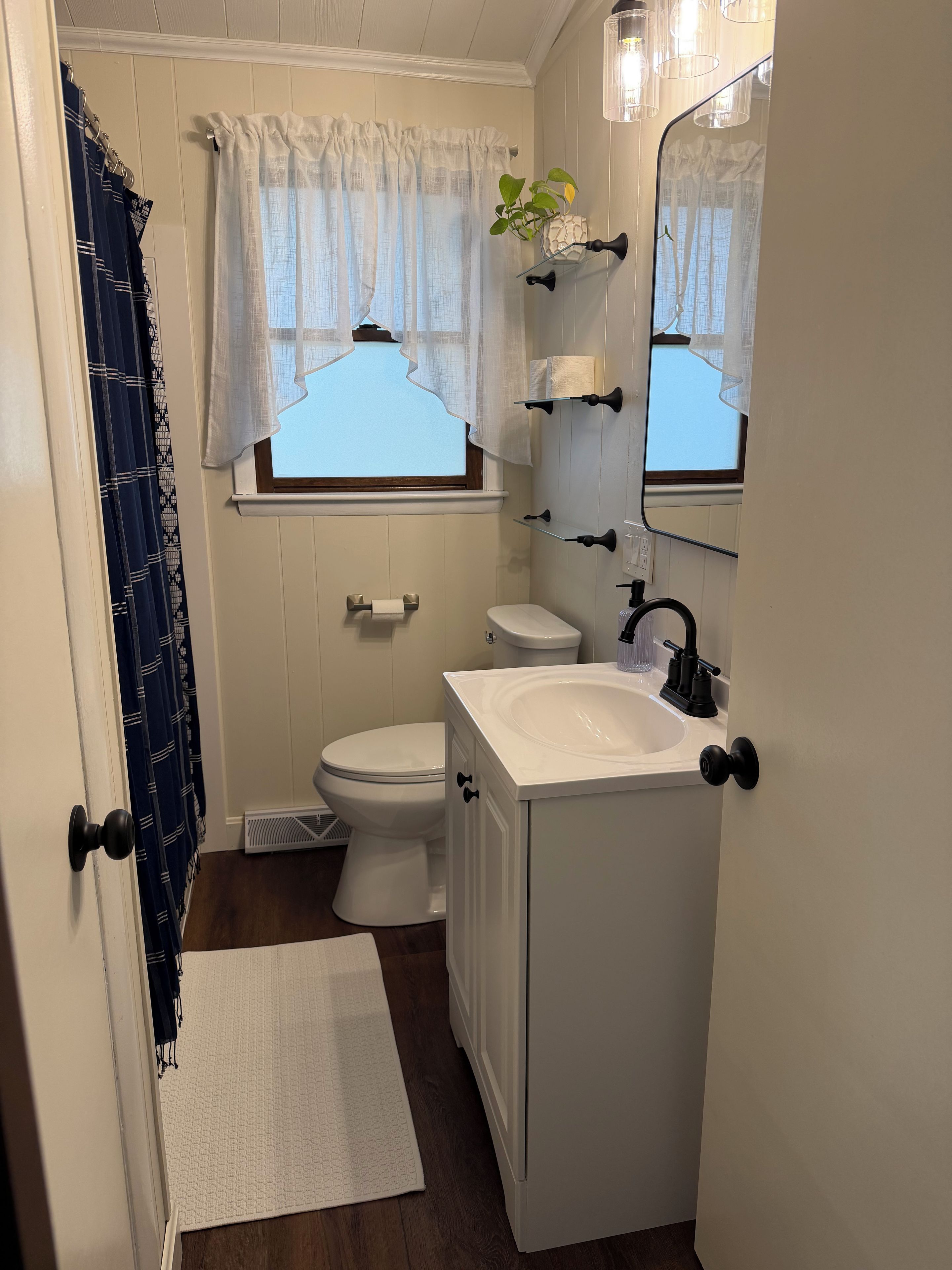 Un bagno piccolo ma funzionale, con toilette, lavandino e specchio.