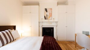 A hotel room with a bed, a fireplace, and a desk. - The Blue Door on Victoria (Footscray)