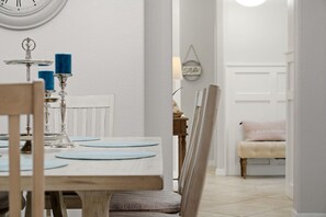 A dining area with a wooden table, chairs, and a clock on the wall. - ⚓Waterview-Resort Style Amenities-Bikes & More⚓ (Bradenton)