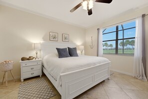 A bedroom with a bed, bedside tables, a ceiling fan, a window with blinds, and a patterned rug. - ⚓Waterview-Resort Style Amenities-Bikes & More⚓ (Bradenton)