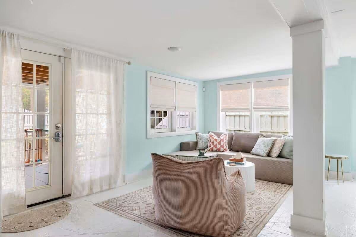A living room with a sofa, a coffee table, and a patterned rug.