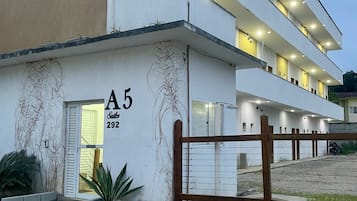 A modern building with a flat facade, a visible entrance, and a number 'A5' on the side.