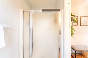 A shower with a glass door, a towel rack, and a plant on the wall. - New! Secluded 9.5-Acre Mountain Retreat with Jewel Basin Views, Near Flathead Lake (Bigfork)
