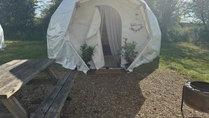 A tent with a welcome mat and a wooden bench outside. - The Leaf & Lantern Dome - Sleeps 5 - Dog Friendly (Pewsey)