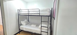 A bunk bed with white bedding and a pink curtain on the upper bunk. - 70s Home Retreat | Pond, Patio & Movie Lounges (Surrey)
