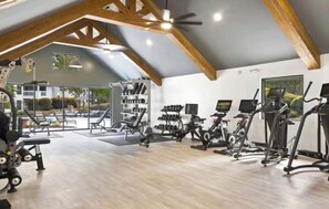 A gym with exercise equipment, a weight rack, and a large window. -  The Nestled Oasis ~ Free Parking ~ Minutes to Duke/Downtown (Durham)