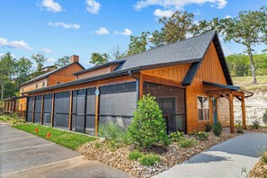 A modern building with large windows, a covered patio, and a landscaped garden. - Near Outdoor Pool&Lazy River_Free Attraction Tickets_Private Hot Tub_Kids Room (Hollister)
