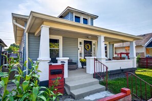 A two-story house with a front porch, a mailbox, and a front yard. - Roadmap Lodging: Craftsman 3BR, Near Downtown Indy (Indianapolis)