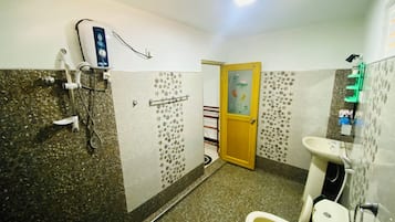 A bathroom with a shower, toilet, and sink.