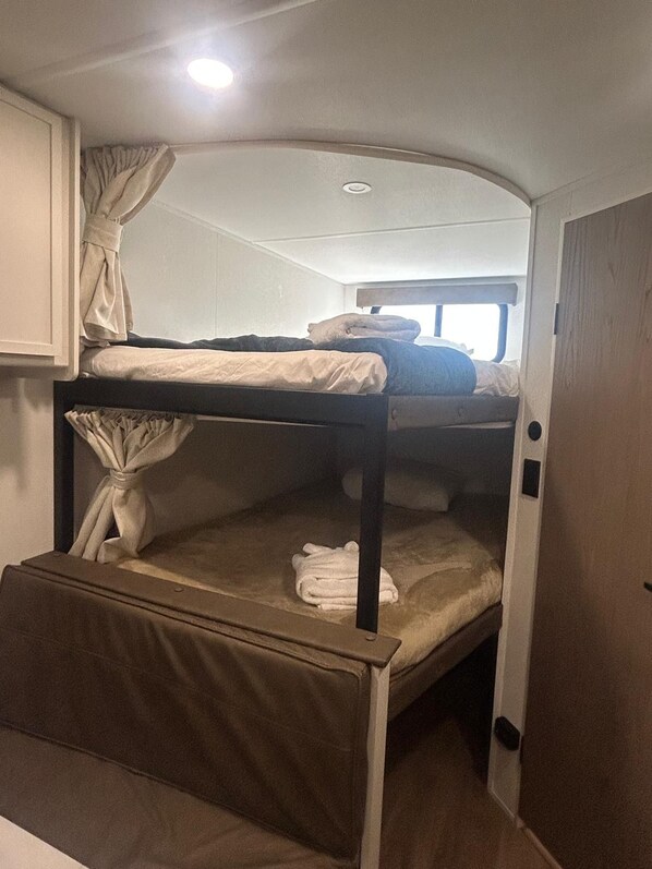 Cozy built-in bunk room with privacy curtains for family-friendly stays